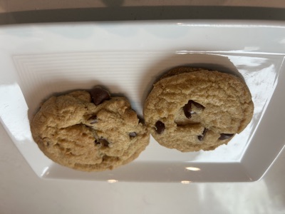 Two Hawaiian sea salt chocolate chip cookies on a white plate